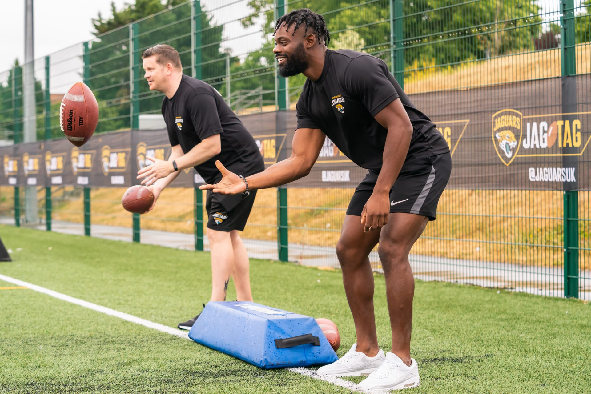 Coaching a catching drill on the training field