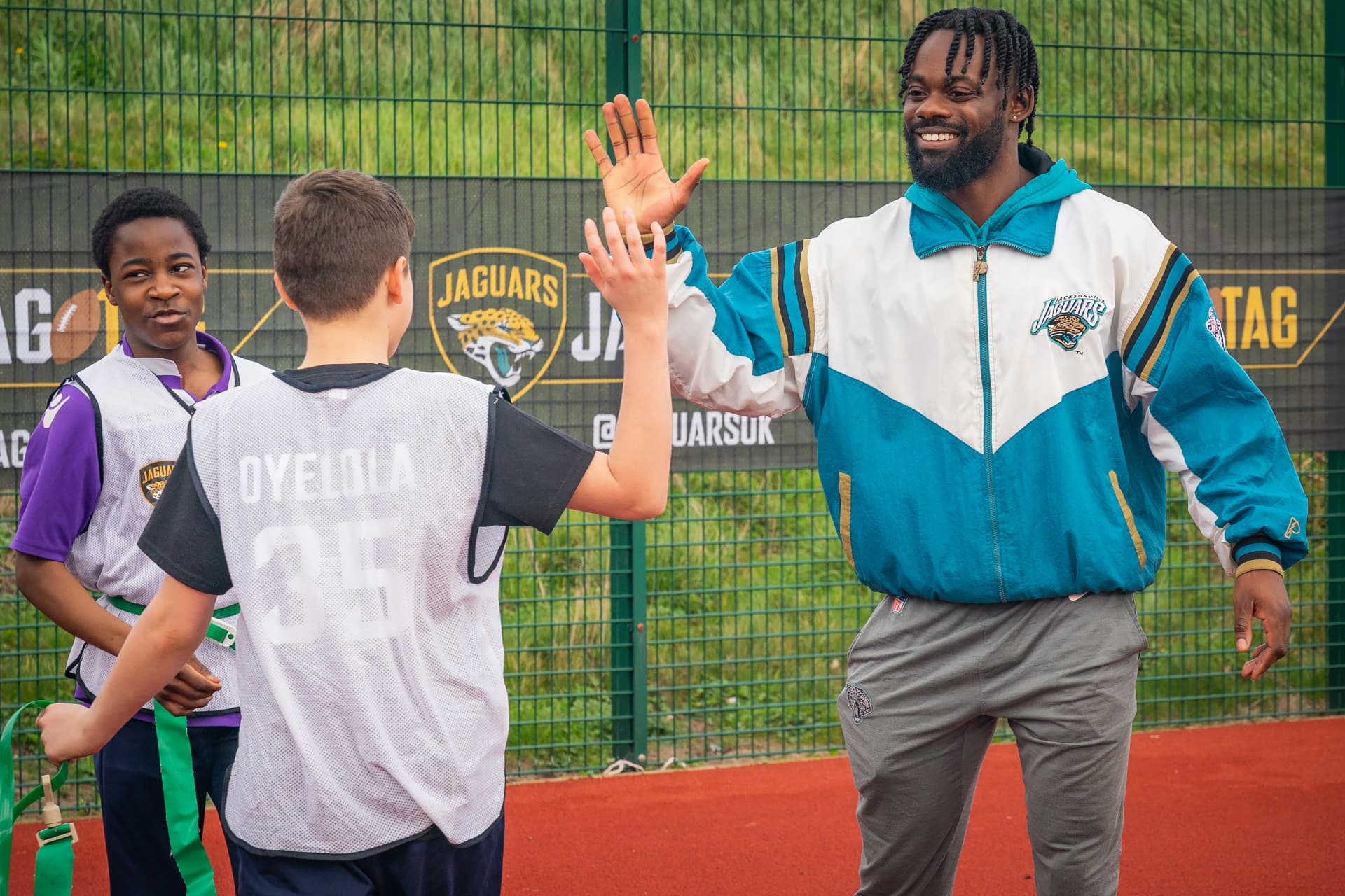 High-fiving a young player wearing an Oyelola jersey